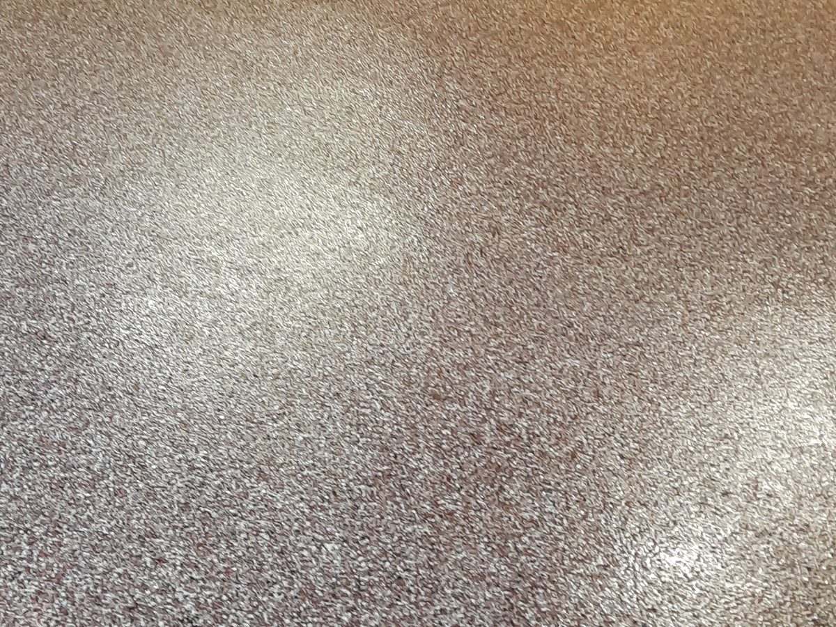 Finished basement floor coating with warm-tone flake blend